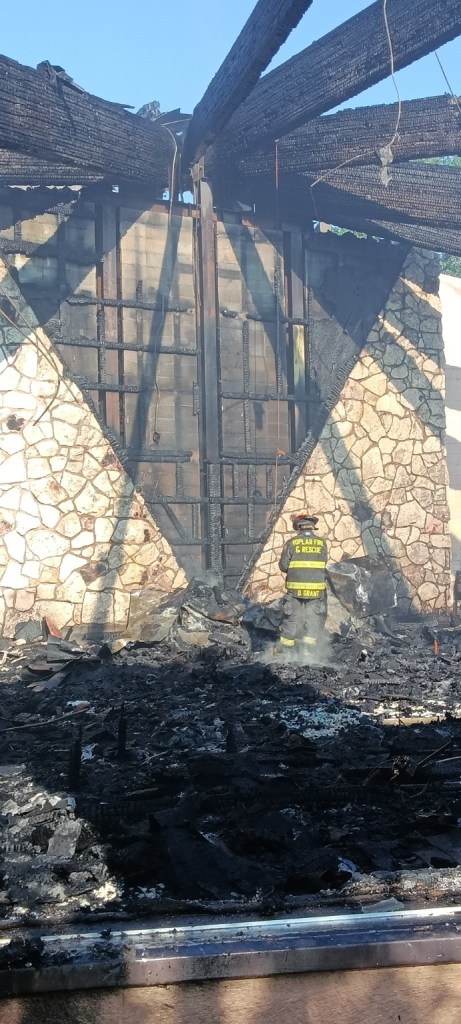 A Poplar firefighter stands inside the gutted remains of Our Lady of Lourdes Catholic Church after the fire.