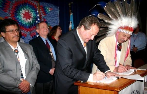 Fort Peck Tribal Chairman A.T. “Rusty” Stafne and Montana Gov. Brian Schweitzer sign state-tribal agreements at Fort Peck in 2008.